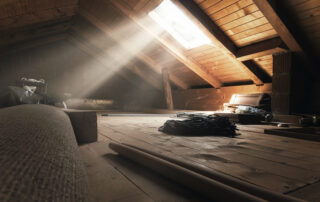 Dusty open attic with sunbeams coming in through a window.