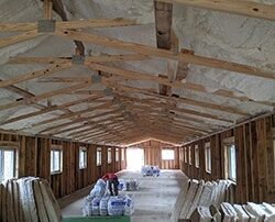 Ceiling insulation in a long renovated barn.