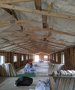 Ceiling insulation in a long renovated barn.
