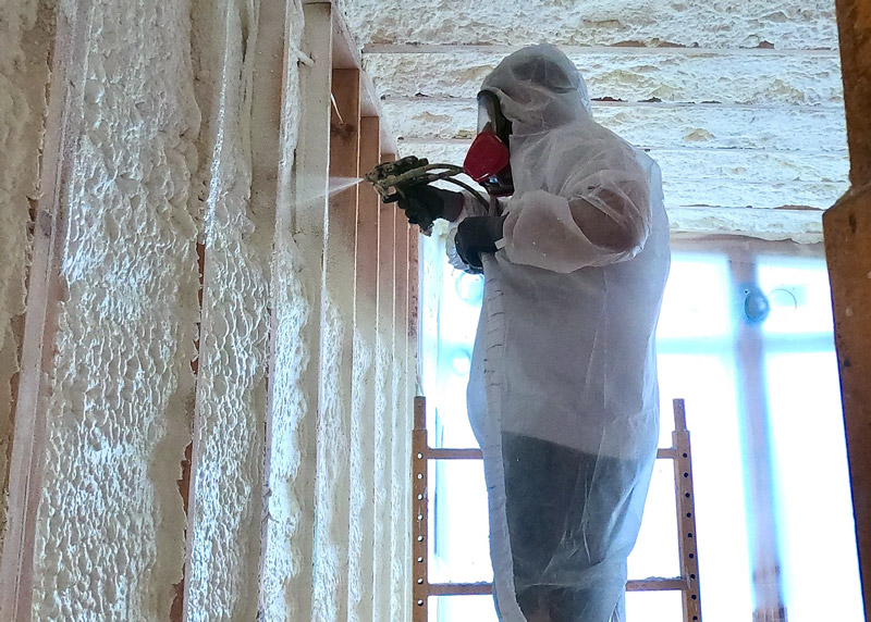 professional installing spray foam insulation