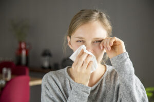 Stressed Girl Suffering From Allergy. Young Woman Covering Nose