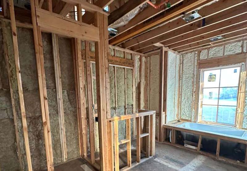 Unfinished bathroom walls with mineral wool batts in a new home build.