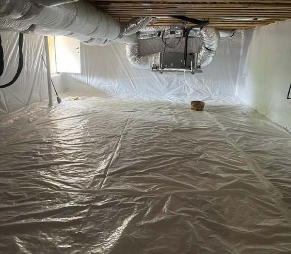 A bright and clean encapsulated crawl space in Nashville, featuring a seamless white vapor barrier covering the floor and walls, protecting HVAC ductwork from ground moisture.