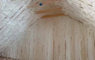 Interior attic view of spray foam insulation. Interior attic view of spray foam insulation covering sloped roof rafters and vertical knee wall in a Nashville residential project.