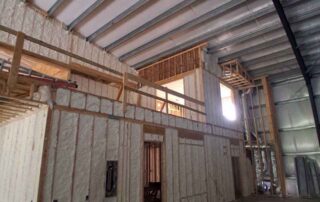 Open-cell spray foam insulation covering wall studs and roof deck. Open-cell spray foam insulation covering wall studs and roof deck.