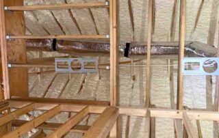 Open-cell spray foam insulation at roof corner intersection with insulated duct run above floor joists, Mt. Juliet, TN — Hayes Insulation Nashville.