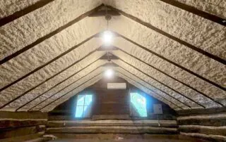 Open-cell spray foam insulation along roofline log walls in historic cabin, Belle Meade Plantation, Nashville, TN.