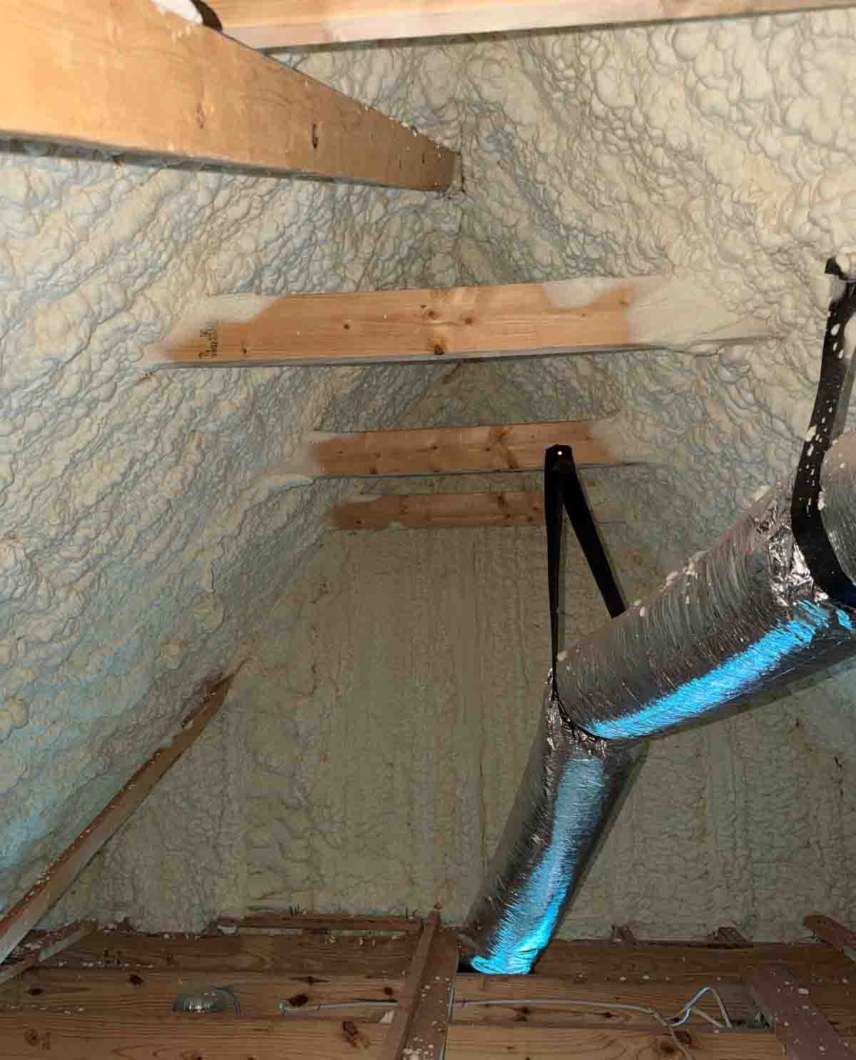 Open-cell spray foam insulation applied to roof deck and rafters with insulated flex duct, Nashville, TN.