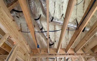 Open-cell spray foam on the roof with fiberglass batt insulation in walls, new AJSF Heritage Homes construction.