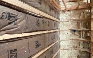 Open-cell spray foam insulation covering roof rafter, new AJSF Heritage Homes construction.